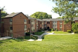 Red brick apartment complex with windows and doors completed by Acadia Windows & Doors.